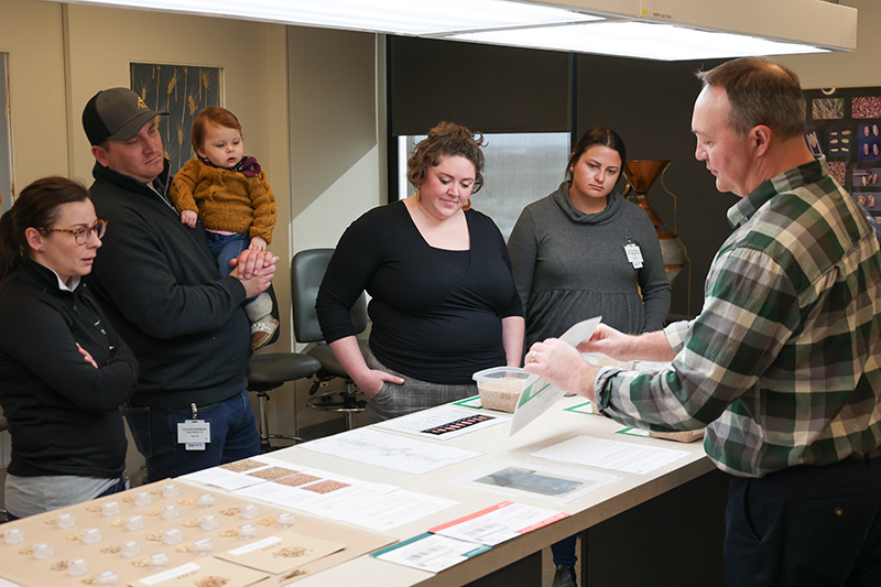 Combine to Customer participants attend a grain grading demonstration. Combine to Customer participants attend a grain grading demonstration.